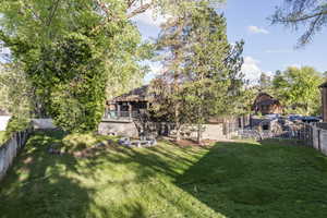 Back of property with a fenced backyard and view of scattered trees