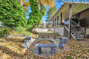 View of yard featuring a fire pit, a patio, and a wooden deck