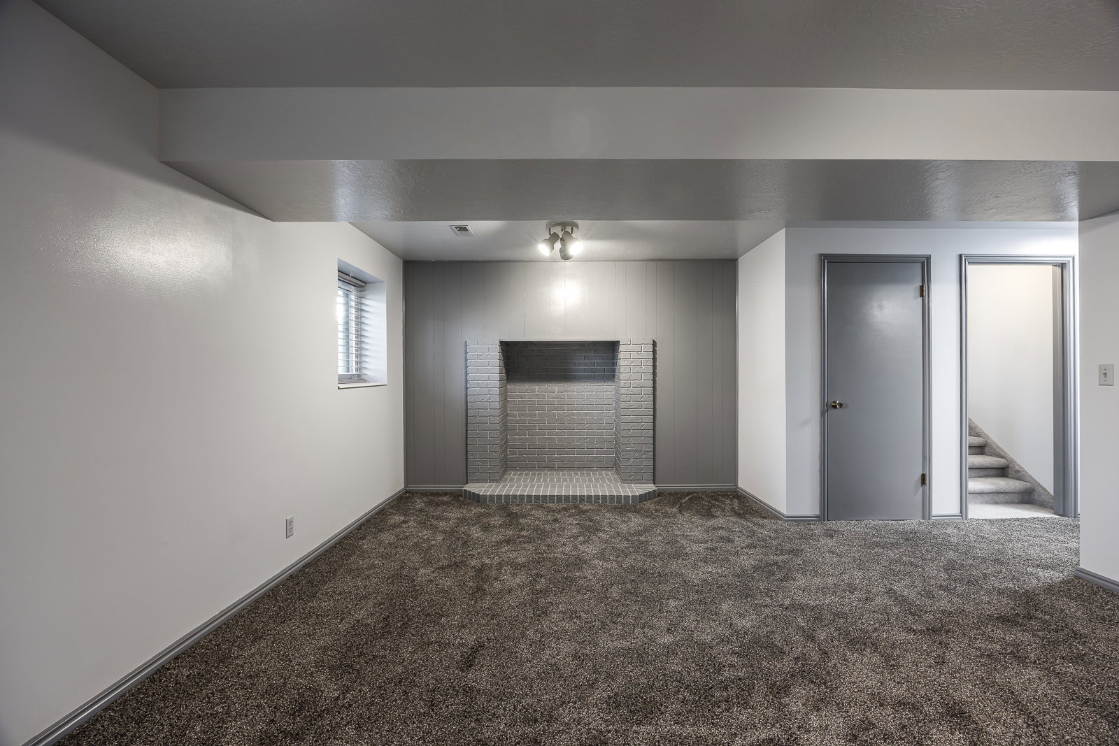 Unfurnished room with dark carpet and stairs
