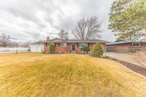Ranch-style home with brick siding and a chimney