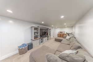 Living area featuring light carpet and recessed lighting