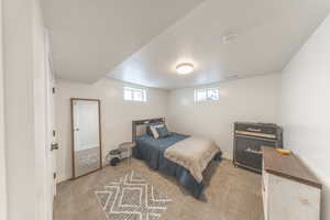 Bedroom featuring light colored carpet and baseboards
