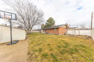 Fenced backyard with a garden and a patio