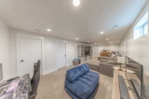 Living room with recessed lighting and light colored carpet