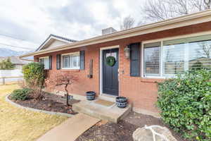 Doorway to property with brick siding
