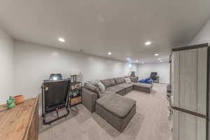Living area featuring recessed lighting and light colored carpet