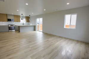 Unfurnished living room with recessed lighting and light wood-style floors
