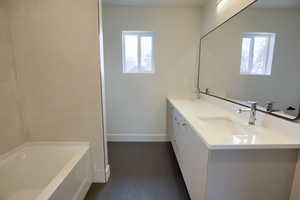 Bathroom with a tub to relax in and double vanity