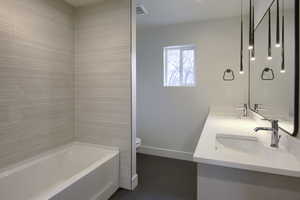Full bathroom featuring double vanity and shower / bath combination