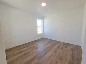 Empty room with dark wood-type flooring