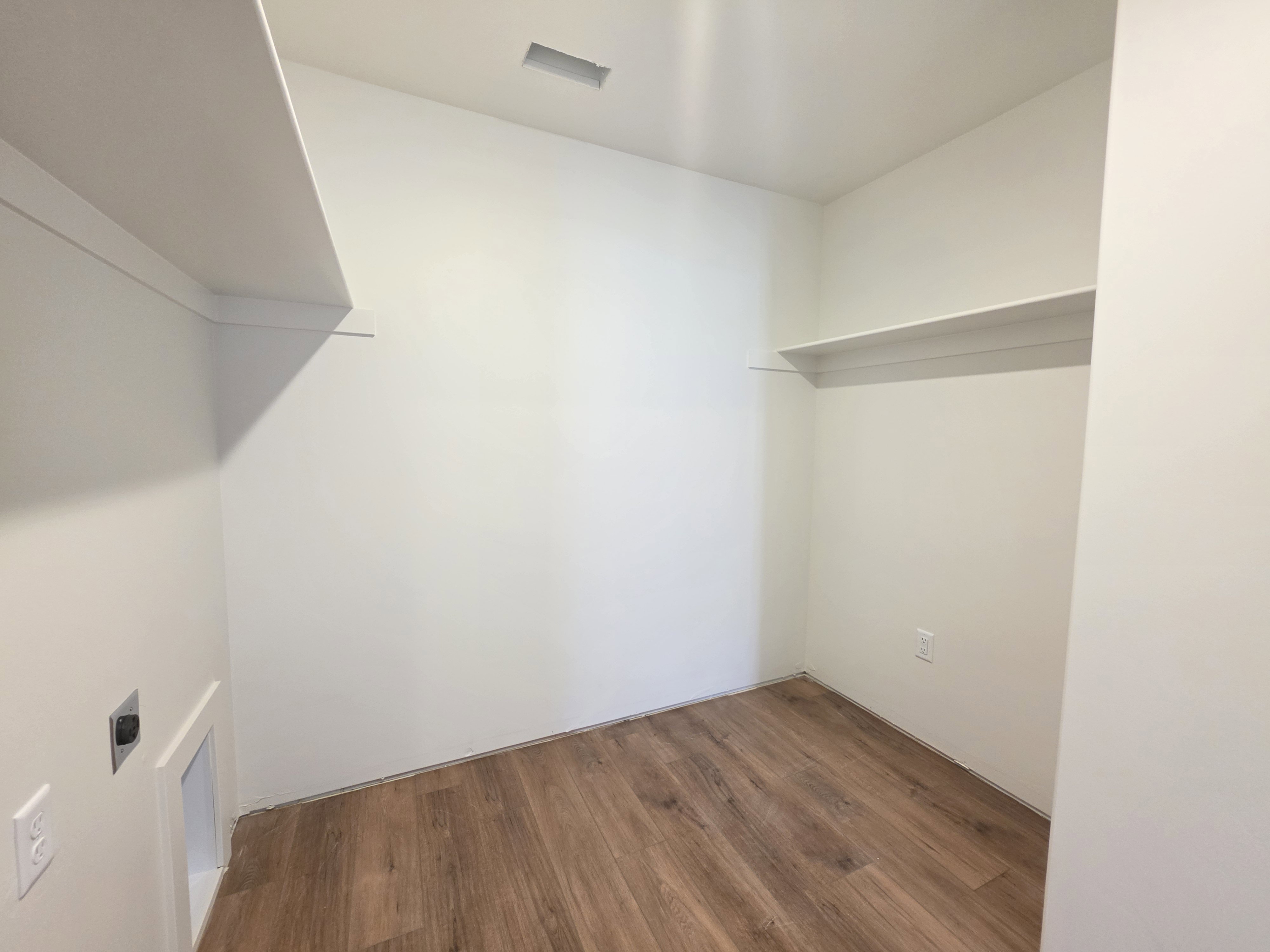 Walk in closet featuring dark wood-style flooring