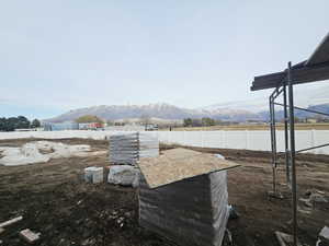 Fenced yard featuring a mountain view