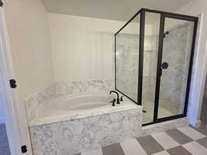 Full bathroom featuring a marble finish shower and a garden tub