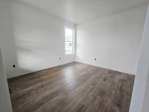 Unfurnished room with dark wood-style floors