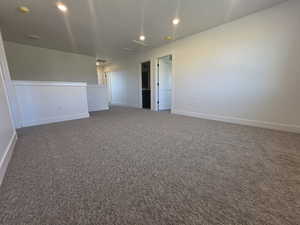 Spare room with dark colored carpet and recessed lighting