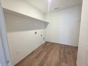 Laundry area featuring dark wood-style flooring, washer hookup, and hookup for an electric dryer
