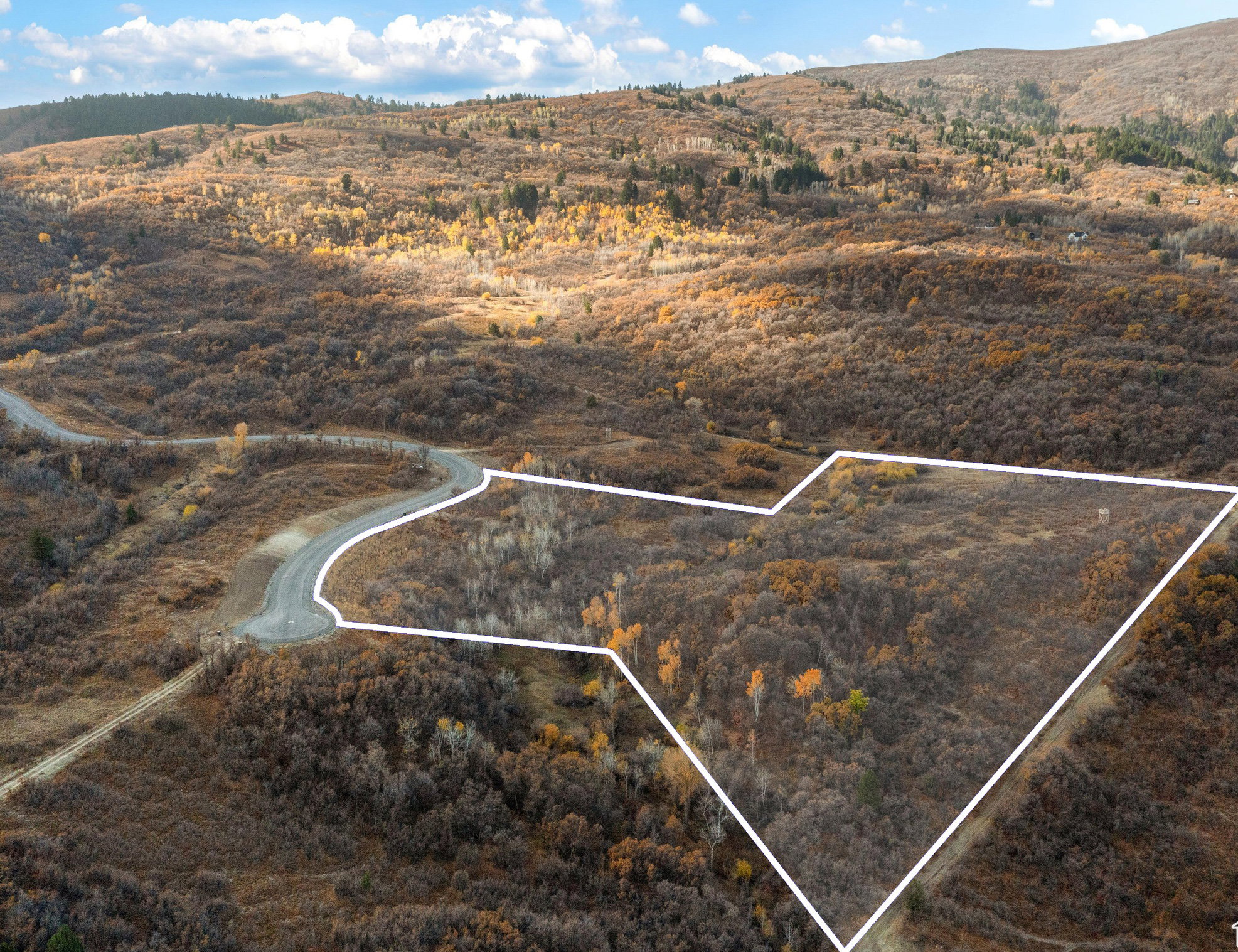 Aerial view of sparsely populated area with property parcel outlined