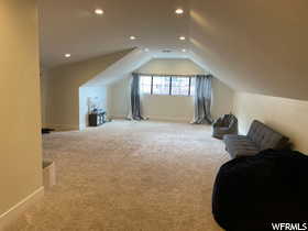 Additional living space with carpet floors and recessed lighting