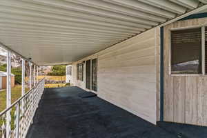 View of patio with a storage unit