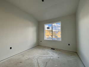 Empty room featuring baseboards