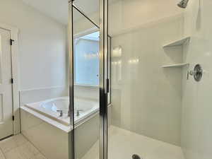 Bathroom featuring a shower stall and a bath