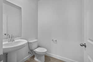 Bathroom featuring toilet and light wood-type flooring