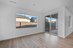 Spare room with light wood-style floors and baseboards