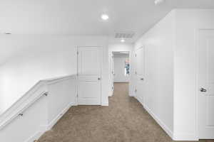 Hall with carpet floors and recessed lighting