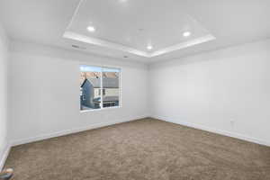 Carpeted empty room featuring baseboards and recessed lighting