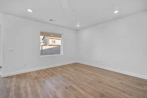 Spare room with light wood-style flooring and recessed lighting