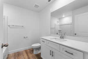Full bathroom with vanity, dark wood-style flooring, and a shower