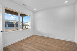 Empty room featuring wood finished floors and recessed lighting