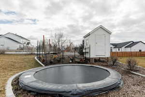 View of yard with a trampoline