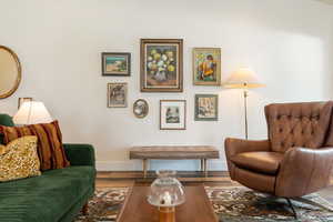 Sitting room featuring baseboards and wood finished floors