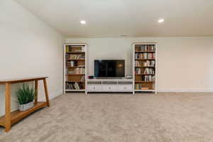 Living area featuring light carpet and recessed lighting