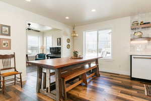 Dining space featuring dark wood-type flooring, a ceiling fan, and recessed lighting