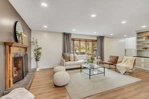 Living room featuring a fireplace and bay window.