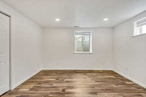 Spare room with wood finished floors and recessed lighting