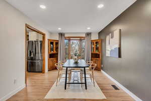 Dining area with a bay window and built-in hutches.