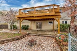 Back of house featuring a patio, an outdoor fire pit, and brick siding