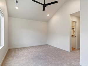 Unfurnished room with light carpet, vaulted ceiling, a ceiling fan, and recessed lighting