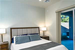 Primary Bedroom with access to exterior and recessed lighting