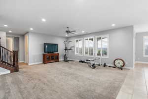 Workout room featuring recessed lighting, a ceiling fan, light carpet, and light tile patterned floors