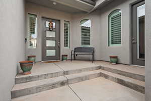 Property entrance with stucco siding