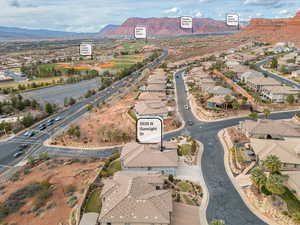 Aerial overview of property's location featuring a mountainous background and nearby suburban area