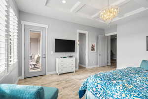 Bedroom with coffered ceiling and a chandelier