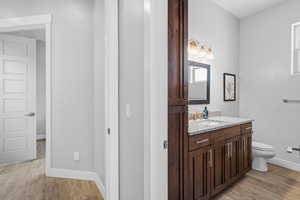 Bathroom featuring vanity and light wood-style floors