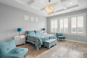 Bedroom featuring suspended lighting and coffered ceiling
