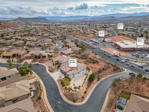 Aerial view of property's location featuring a mountain backdrop