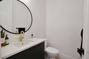 Powder Bathroom with vanity and toilet